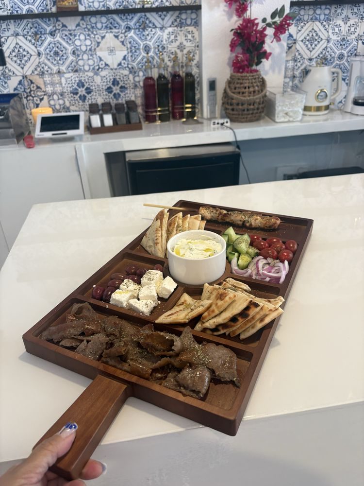 The Ellada meze board: gyro, souvlaki, feta, olives, tzatziki, and grilled pita